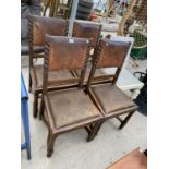 FOUR CARVED OAK AND STUDDED LEATHER DINING CHAIRS