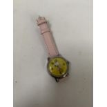 A CHILD'S WRIST WATCH WITH SNOOPY FACE AND PINK STRAP