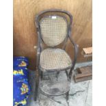 A VINTAGE WOOD AND RATTAN HIGHCHAIR