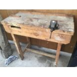 A WOODEN WORK BENCH WITH SMALL VICE NO.0