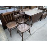 AN OVAL OAK DROP LEAF DINING TABLE ON BARLEY TWIST SUPPORTS AND THREE OAK DINING CHAIRS