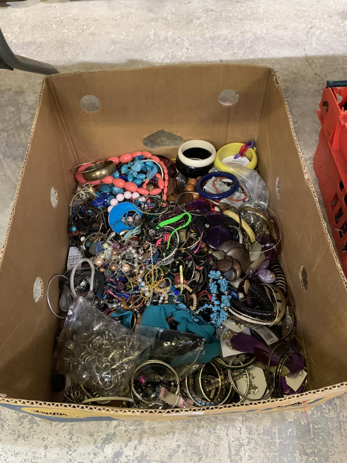 A LARGE CARDBOARD BOX CONTAINING ASSORTED COSTUME JEWELLERY