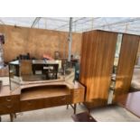 A TEAK DRESSING TABLE WITH FIVE DRAWERS AND UPPER THREE SECTION UNFRAMED MIRROR AND A TEAK WARDROBE