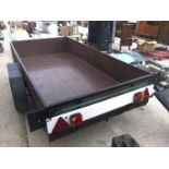 AN 8FT X 4FT WOODEN CAR TRAILER WITH TRAILER BOARD AND INTEGRATED BRAKING SYSTEM IN GOOD CONDITION