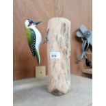 A PAINTED WOODPECKER MODEL ON WOODEN BASE