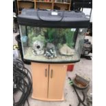 A FISH TANK ON A BEECH EFFECT STAND WITH ORNAMENTS, STONES ETC 120CM TALL WITH BASE AND 60CM WIDE