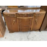 AN OAK SIDEBOARD WITH FIVE DRAWERS AMD TWO DOORS