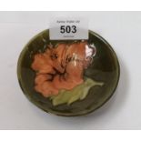 A MOORCROFT POTTERY HIBISCUS PATTERN SMALL DISH, PAPER LABEL TO BASE