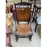 A VICTORIAN OAK ROCKING CHAIR WITH PATTERNED SEAT AND BACK