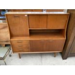 A RETRO TEAK SIDEBOARD WITH TWO LOWER DOORS, THREE DRAWERS, UPPER FALL FRONT AND TWO SLIDING DOORS