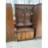 A MAHOGANY CABINET WITH TWO LOWER DOORS AND TWO UPPER GLAZED PANEL DOORS