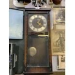 A MAHOGANY CASED ACTIM 30 DAY WALL CLOCK