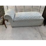 AN UPHOLSTERED DAYBED WITH HINGED STORAGE COMPARTMENT