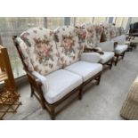AN ERCOL OAK COTTAGE THREE PIECE SUITE COMPRISING A TWO SEATER SOFA AND TWO ARMCHAIRS