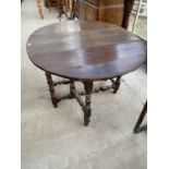 A GEORGIAN OVAL DROP LEAF OAK DINING TABLE ON BOBBIN TURNED SUPPORTS