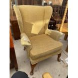 A WING BACK ARMCHAIR ON MAHOGANY CABRIOLE SUPPORTS (FOR RE-UPHOLSTERY)