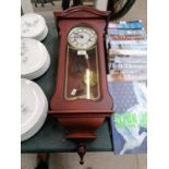 A LINCOLN 31 DAY WALL CLOCK WITH PENDULUM AND KEY
