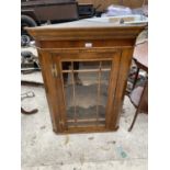 A VICTORIAN OAK FLAT FRONT CORNER CUPBOARD WITH MAHOGANY FRIEZE, GLAZED PANEL DOOR AND BRASS H