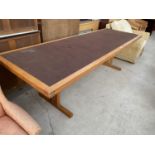 A LONG TEAK DINING TABLE