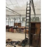 A VINTAGE TWENTY FOUR RUNG TWO SECTION WOODEN LADDER AND A QUANTITY OF PLASTIC GARDEN TROUGHS