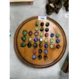 A VICTORIAN SOLITAIRE BOARD WITH MARBLES