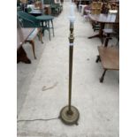 A BRASS STANDARD LAMP ON CIRCULAR TRIPOD SUPPORT