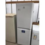 AN INDESIT FRIDGE FREEZER IN NEED OF CLEAN IN WORKING ORDER