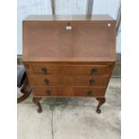 A BURR WALNUT BUREAU ON CABRIOLE SUPPORTS WITH FALL FRONT AND THREE DRAWERS
