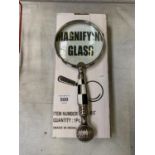 A BOXED MAGNIFYING GLASS WITH CHEQUERED HANDLE