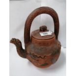 AN ORIENTAL TERRACOTTA YIXING STYLE TEAPOT