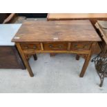 AN INDONESIAN WOOD SIDE TABLE WITH THREE DOORS