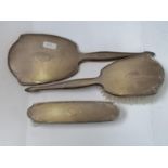 A BIRMINGHAM HALLMARKED SILVER THREE PIECE DRESSING SET, MIRROR, CLOTHES BRUSH AND HAIR BRUSH