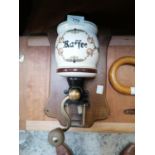 A VINTAGE CERAMIC COFFEE GRINDER ON WOODEN PLINTH