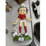 A CAST METAL BETTY BOOP DOOR STOP MODEL IN RED FOOTBALL KIT