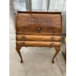 A WALNUT ROLL TOP BUREAU ON CABRIOLE SUPPORTS WITH TWO DRAWERS AND LEATHER WRITING SURFACE