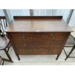 AN OAK CHEST OF THREE LONG DRAWERS