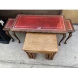 AN OAK NEST OF TABLES AND A MAHOGANY NEST OF TABLES WITH RED LEATHER TOPS