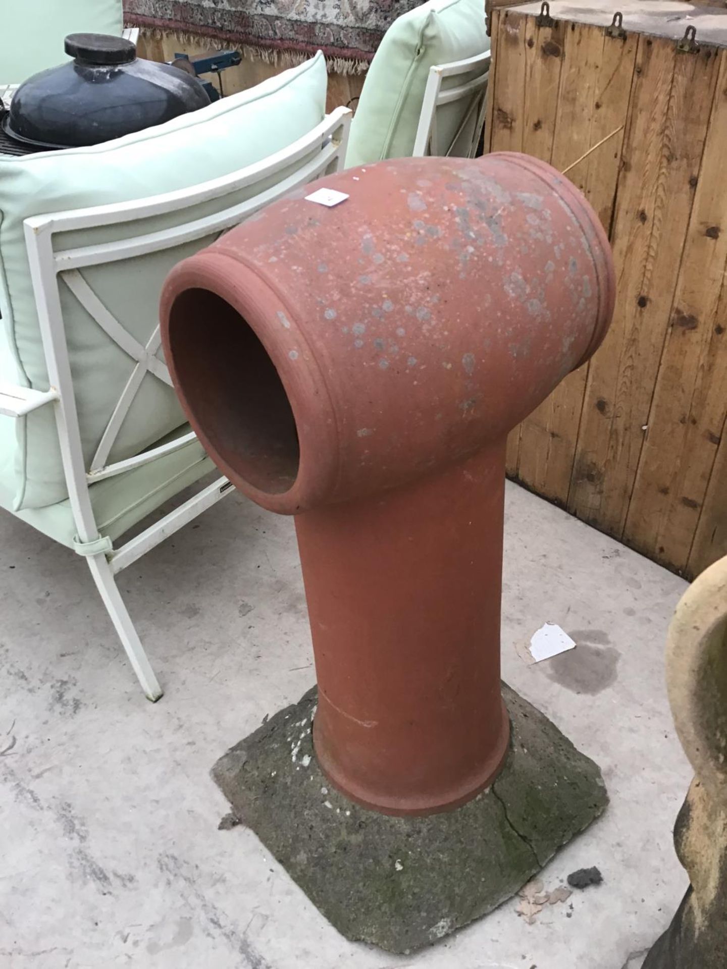 A LARGE RED COLOURED CHIMNEY POT