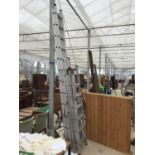 THREE SETS OF ALUMINIUM LADDERS TO INCLUDE A TWENTY FOUR RUNG TWO SECTION, A FOURTEEN RUNG FOLDING