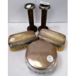 A MIXED LOT OF SILVER ITEMS - SILVER TOPPED BRUSHES, SILVER TOPPED JAR AND WOODEN CANDLESTICKS