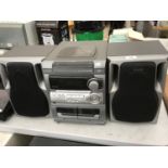 AN AWIA STEREO UNIT WITH SPEAKERS IN WORKING ORDER