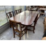 AN EXTENDING MAHOGANY DINING TABLE WITH SIX CHAIRS AND TWO CARVERS