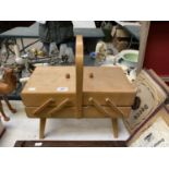 A WOODEN SEWING BOX AND CONTENTS