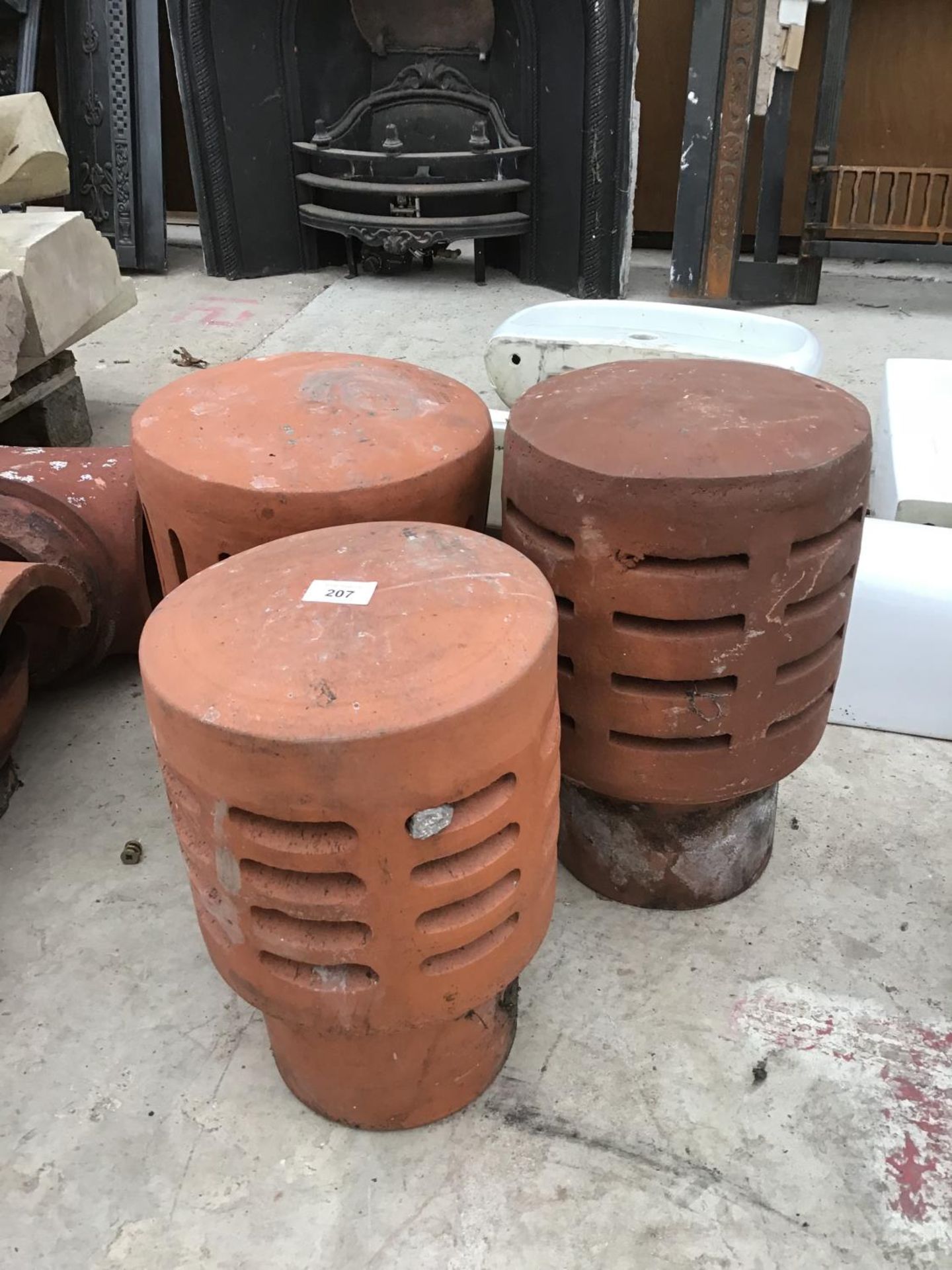 THREE TERRACOTTA CHIMNEY POT TOPS