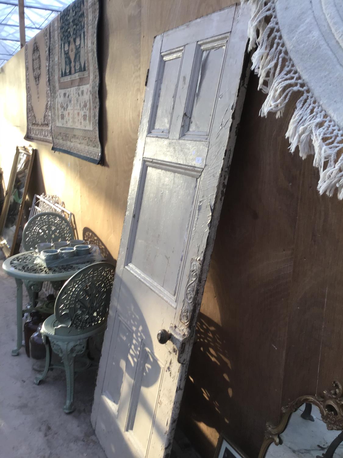 A VINTAGE WOODEN DOOR WITH ORIGINAL HANDLE AND AN ORNATE DOOR PLATE 76CM X 205CM