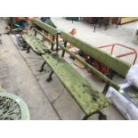 TWO WOODEN BENCHES ON CAST IRON SUPPORTS IN NEED OF RESTORATION