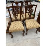 FOUR CHIPPENDALE STYLE CARVED MAHOGANY DINING CHAIRS ON BALL AND CLAW FEET