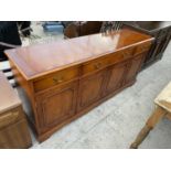 A YEW WOOD SIDEBOARD WITH FOUR DOORS AND FOUR DRAWERS