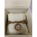 A LADIES WRIST WATCH ON YELLOW METAL CHAIN, BOXED