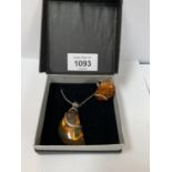 A BOXED SILVER NECKLACE WITH AMBER DESIGN WITH RING